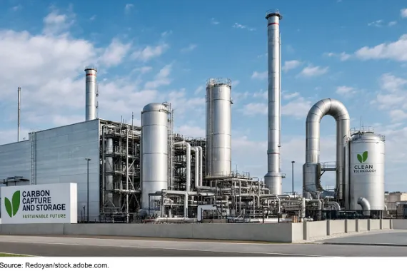 Industrial carbon capture and storage facility with tall metal towers, and pipes.