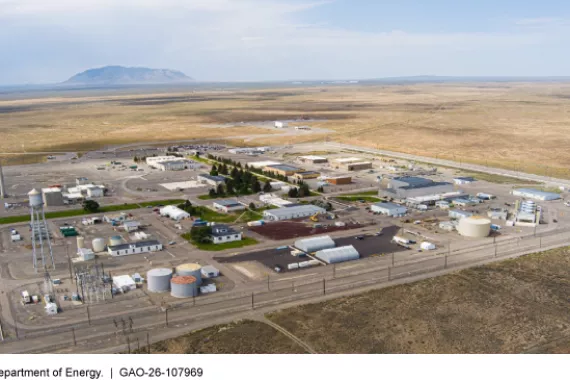 A plot of land with several buildings, storage units, and silos.  