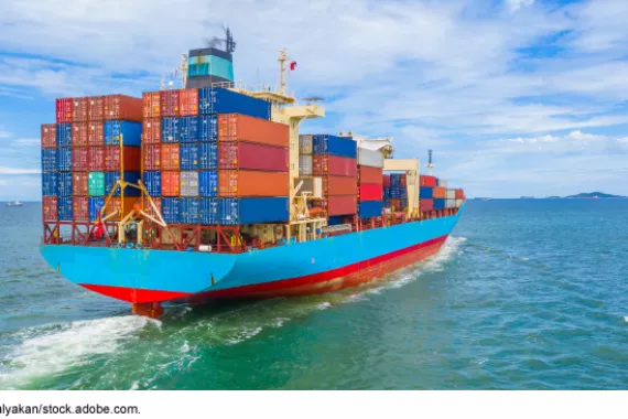 A large cargo ship sailing towards land.
