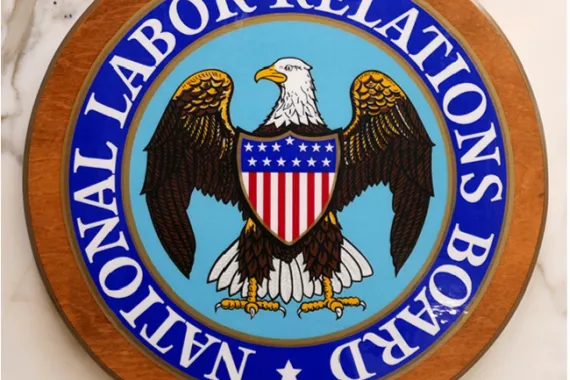 A round emblem with an American eagle in the middle and the words National Labor Relations Board circulating around it.