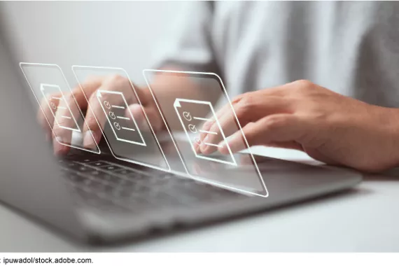 A person's hands typing on a laptop with an illustration of icons of checklists floating above the keyboard. 