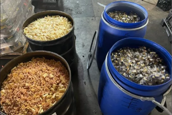 Four large barrels full of pieces of e-cigarettes.