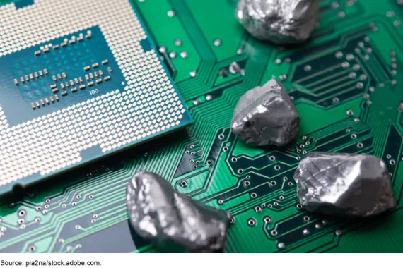 An electronic chip with small rock-like items on it.