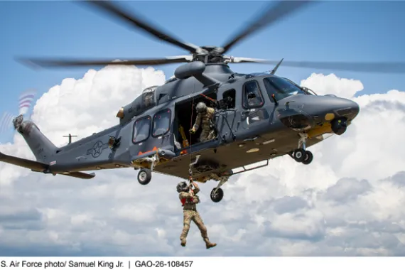 Photo of a person rappelling from a helicopter in flight