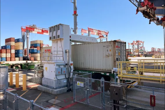 A cargo container being scanned at a port.