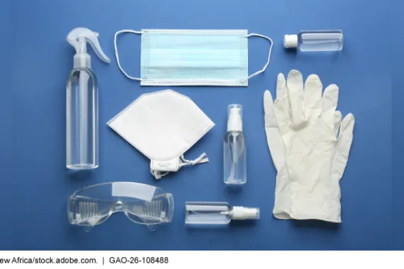 Flat lay composition with medical gloves, protective googles, masks, and hand sanitizer on blue background