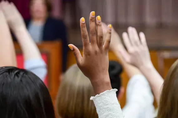 Photo of students' raised hands