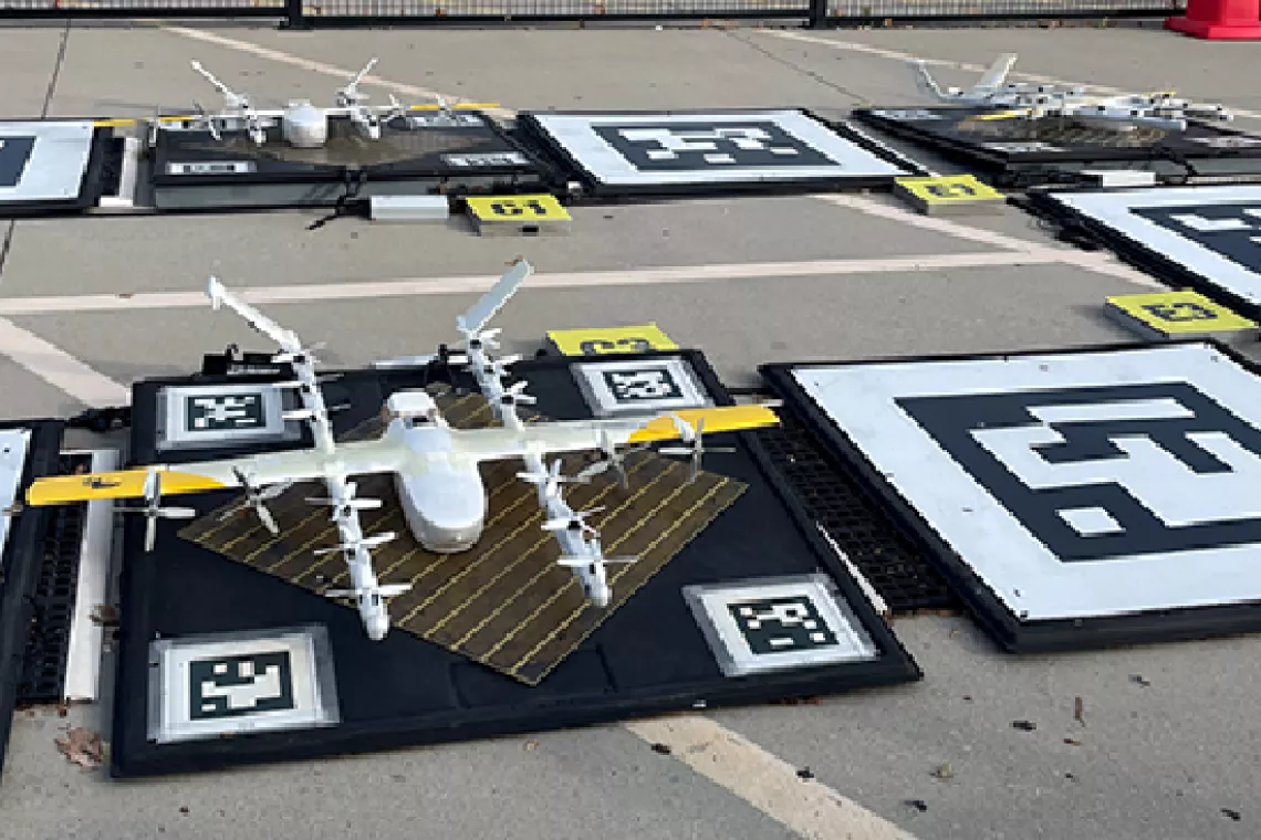 Drone on a launch pad in a parking lot.