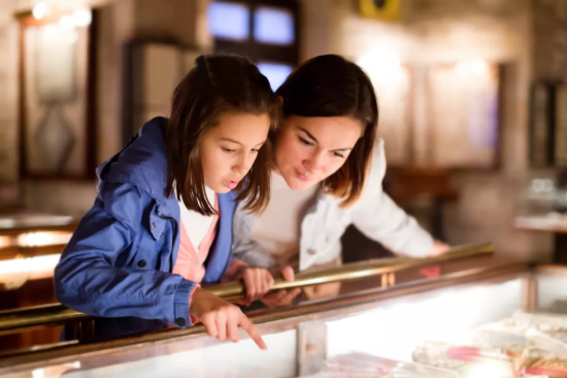 A mother and daughter in a museum