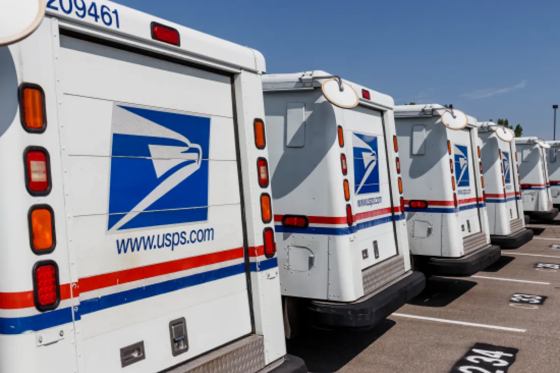 A photo of United States Postal Service vehicles.