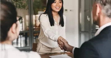 People shaking hands during a job interview. 